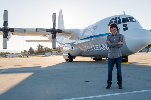 Boyan Slat in front of Ocean Force One at Moffett Airfield in Mountain View, California