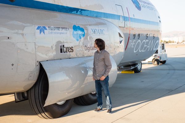 Boyan Slat next to Ocean Force One at Moffett Airfield in Mountain View, California